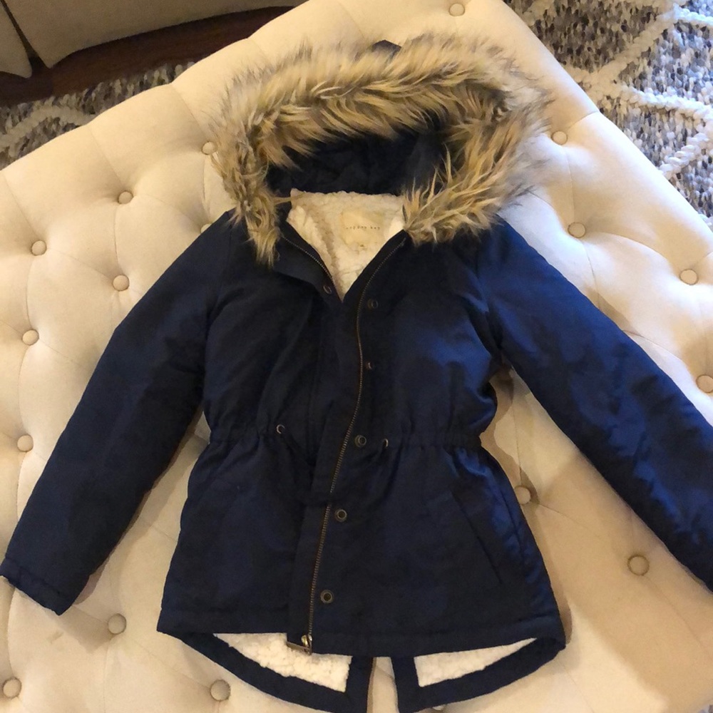Hip length navy puffer coat.